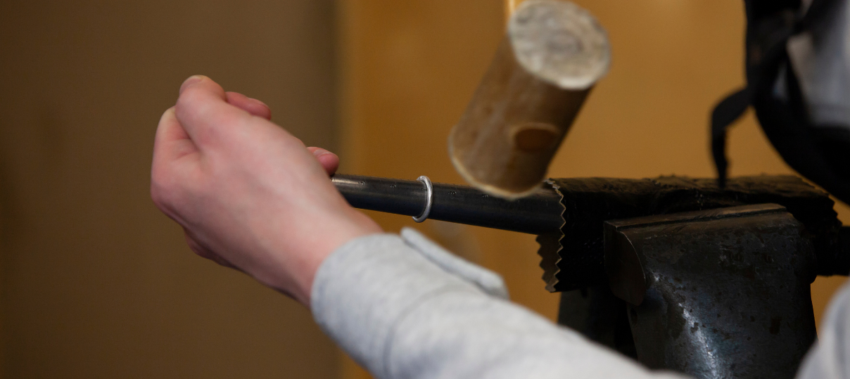 Student hammering simple band ring