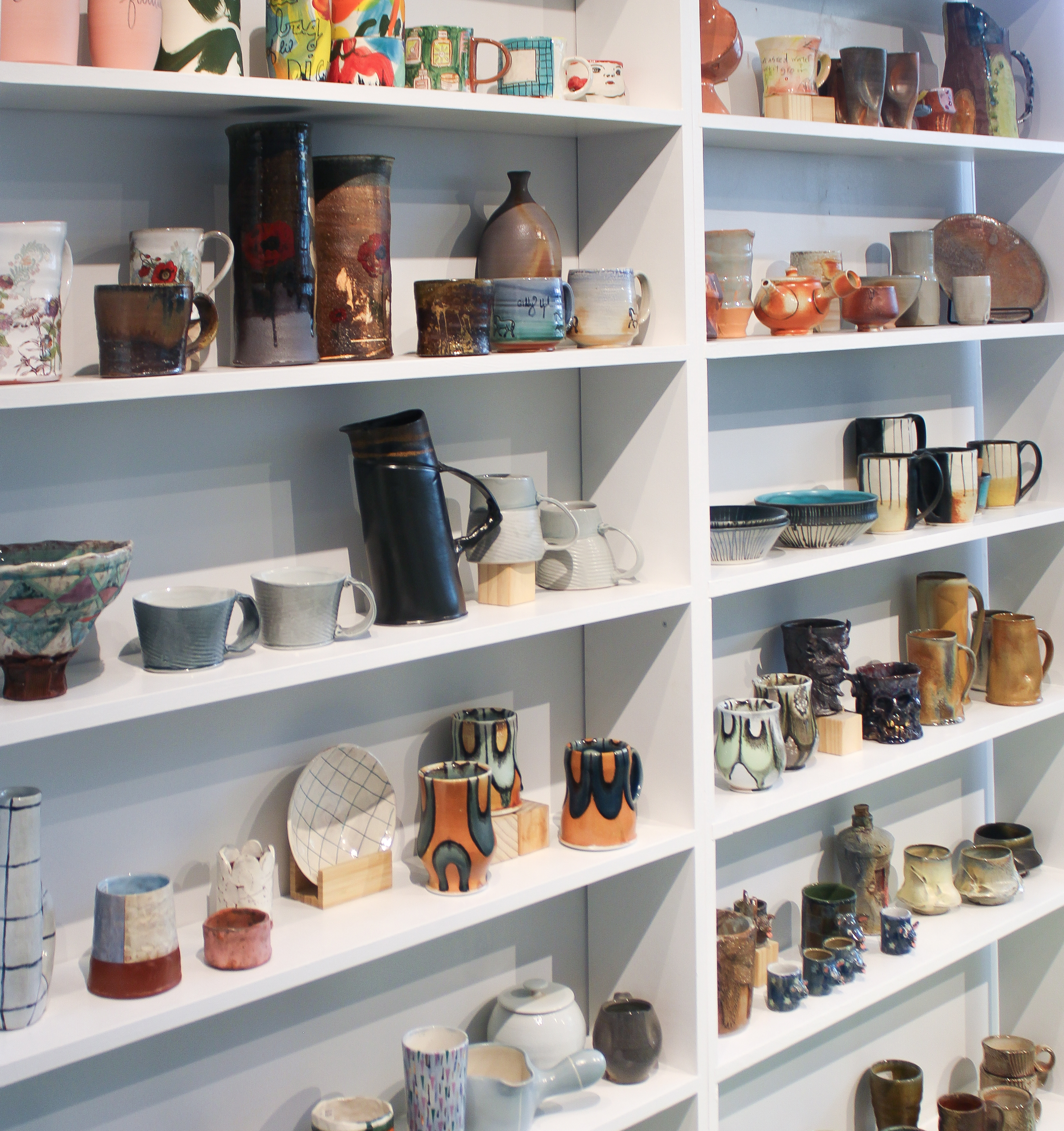 Ceramic pieces on white shelves