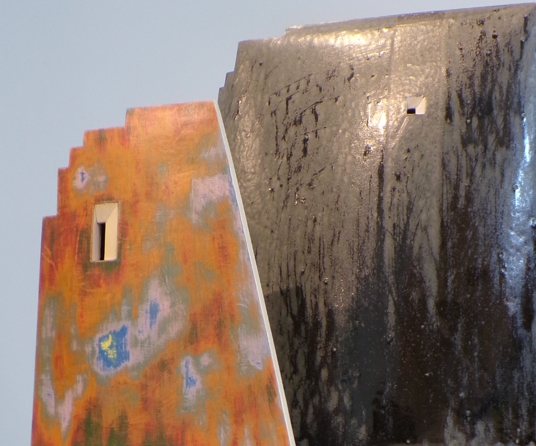 Detail shot of an orange and black ceramic sculpture.