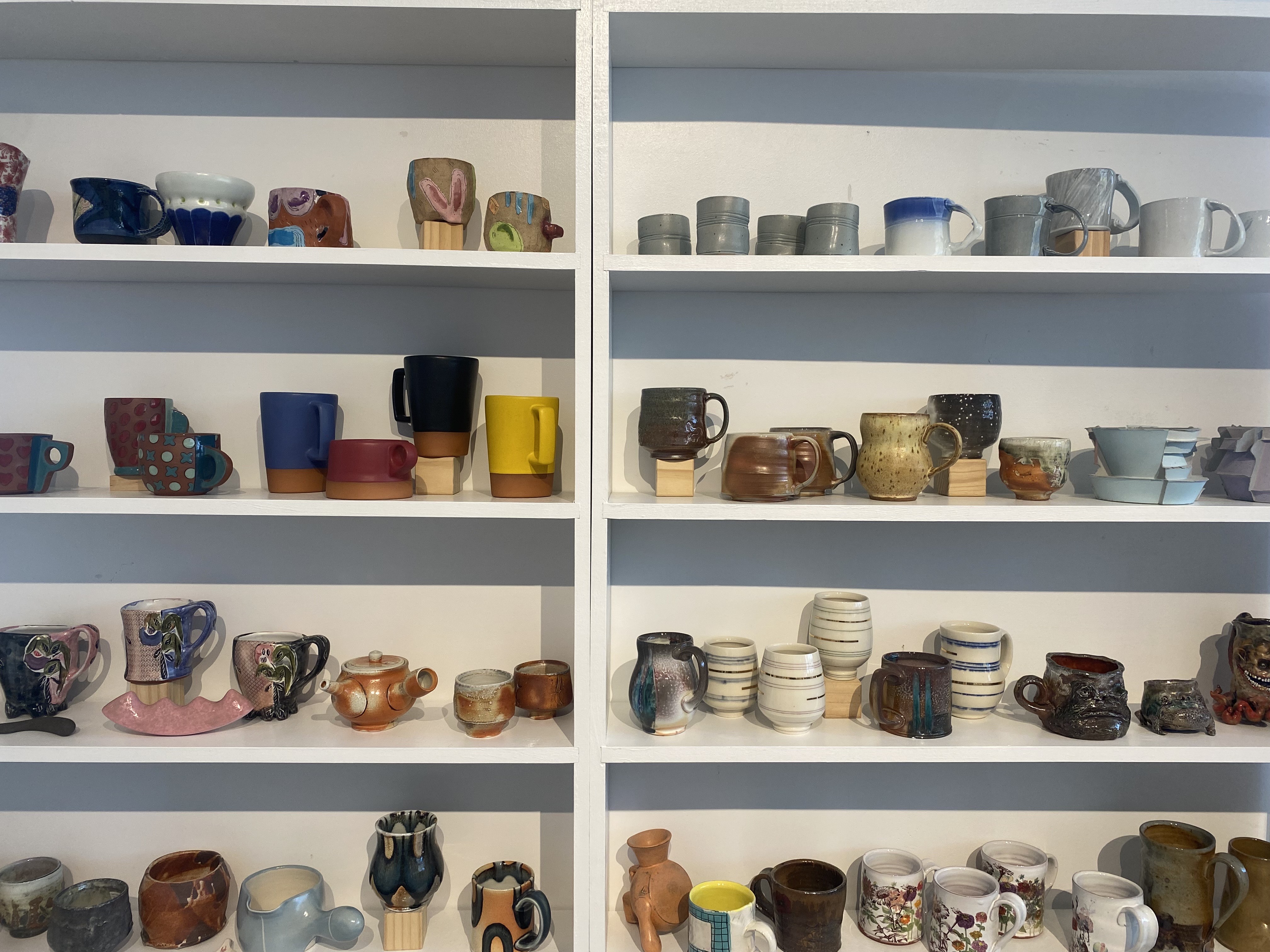 Ceramic pieces on white shelves