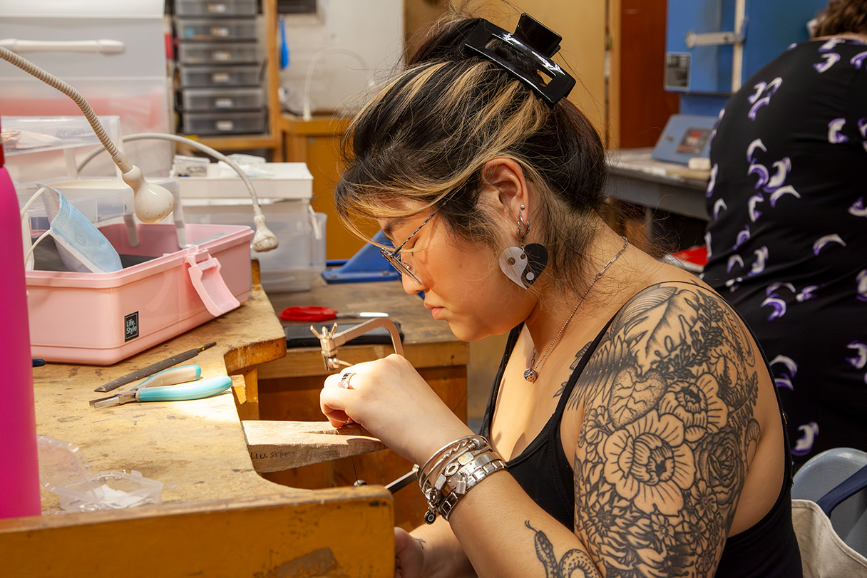 A metalsmither in the studio.